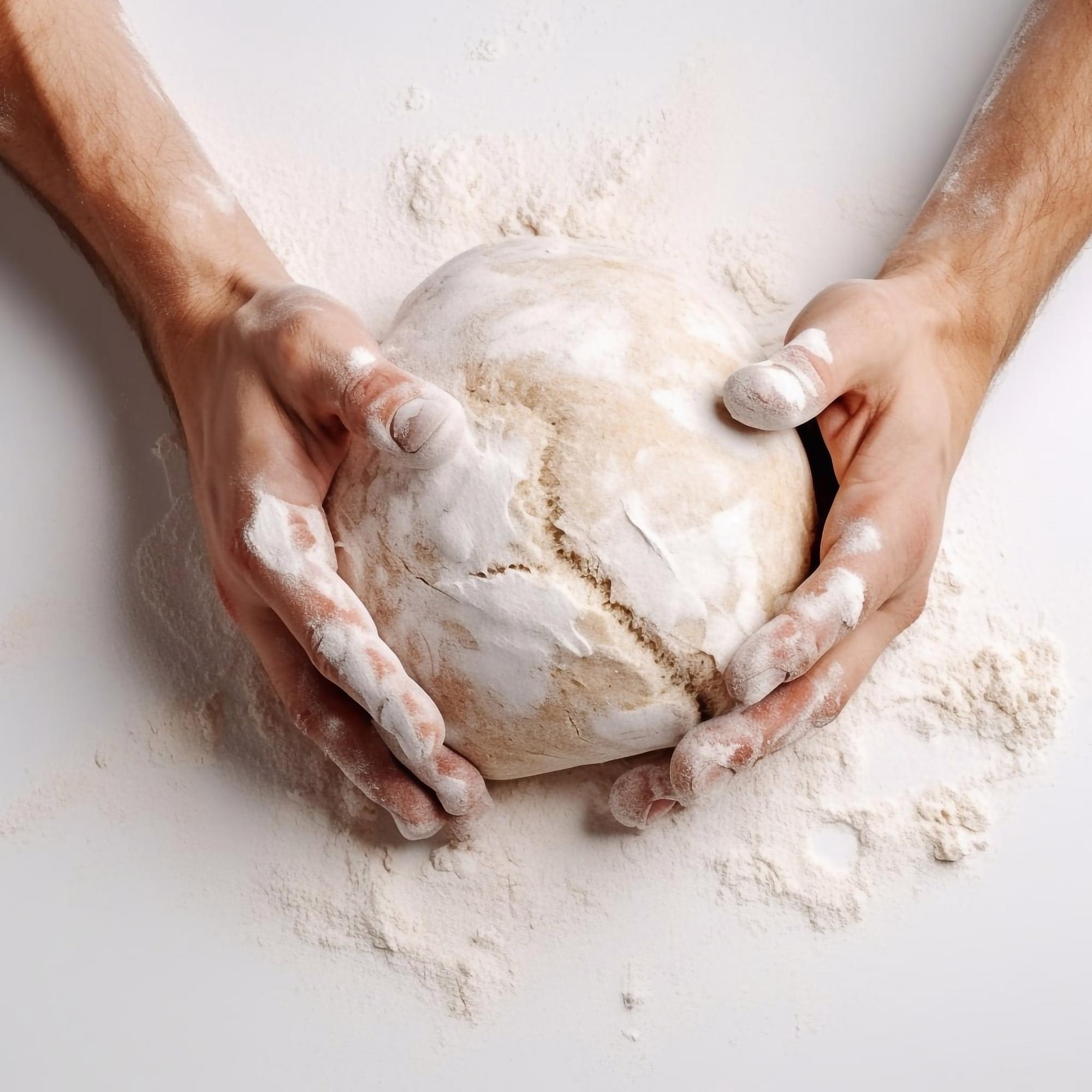 Chef shaping dough in warm kitchen